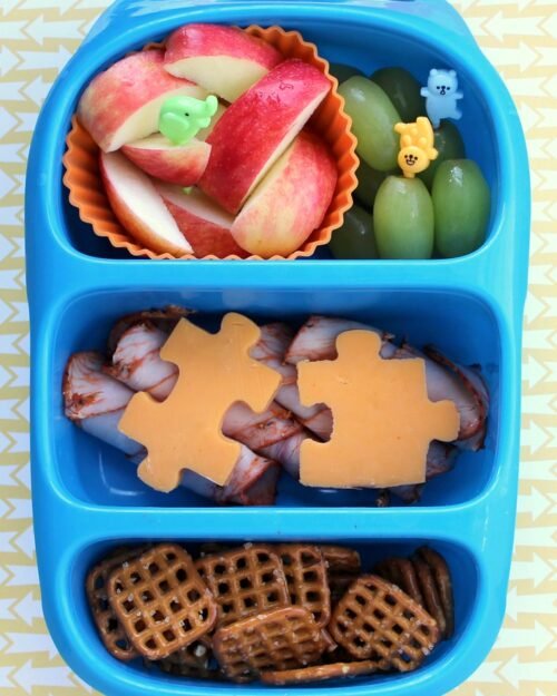 Open compartment lunch box with food portions