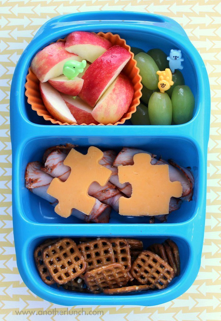 Open compartment lunch box with food portions